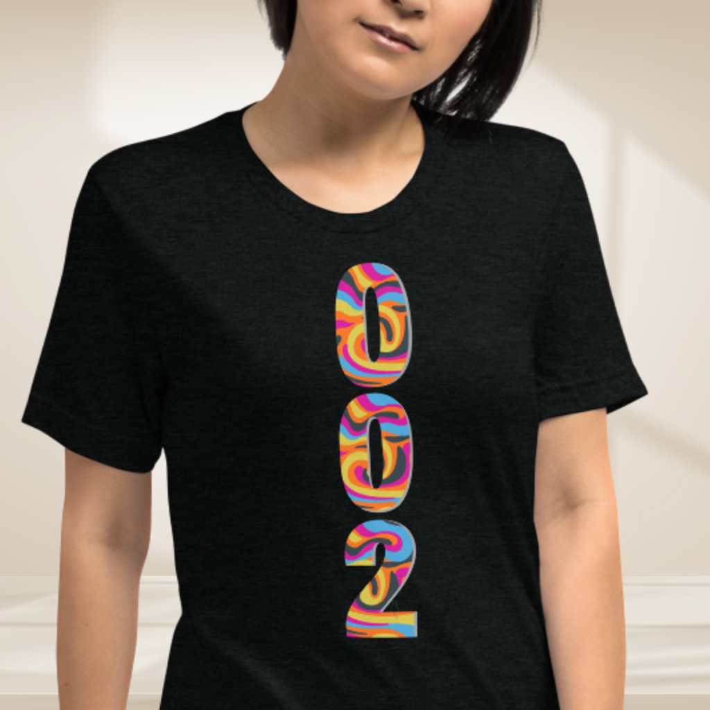 Close-up of PeaMac Pickleball Tees unisex pickleball T-shirt with a vibrant psychedelic tri-blend design.