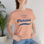 Red and blue pickleball T-shirt with script logo, featuring paddle and ball design, by Printify.