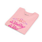 Pink Dinking Diva youth pickleball shirt with filigree design, made for kids, featuring vibrant pink fabric and stylish print.