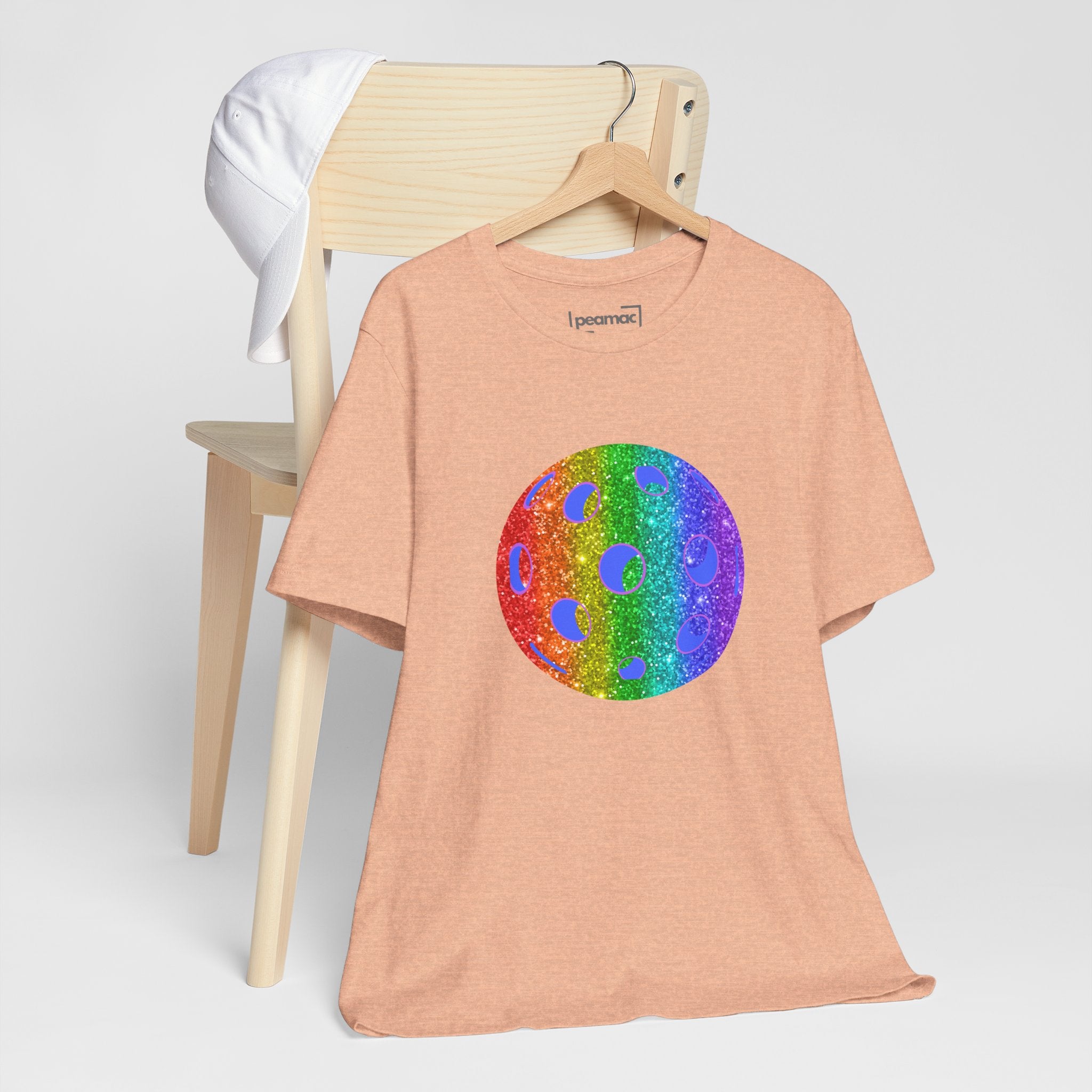 Rainbow glitter pickleball pride T-shirt featuring colorful "Loud and Proud" design, celebrating LGBTQ+ pride and pickleball sport.