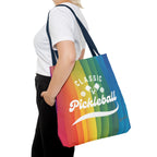 Colorful pickleball tote bag with crossed paddles and script design, featuring vibrant rainbow stripes, by Printify.