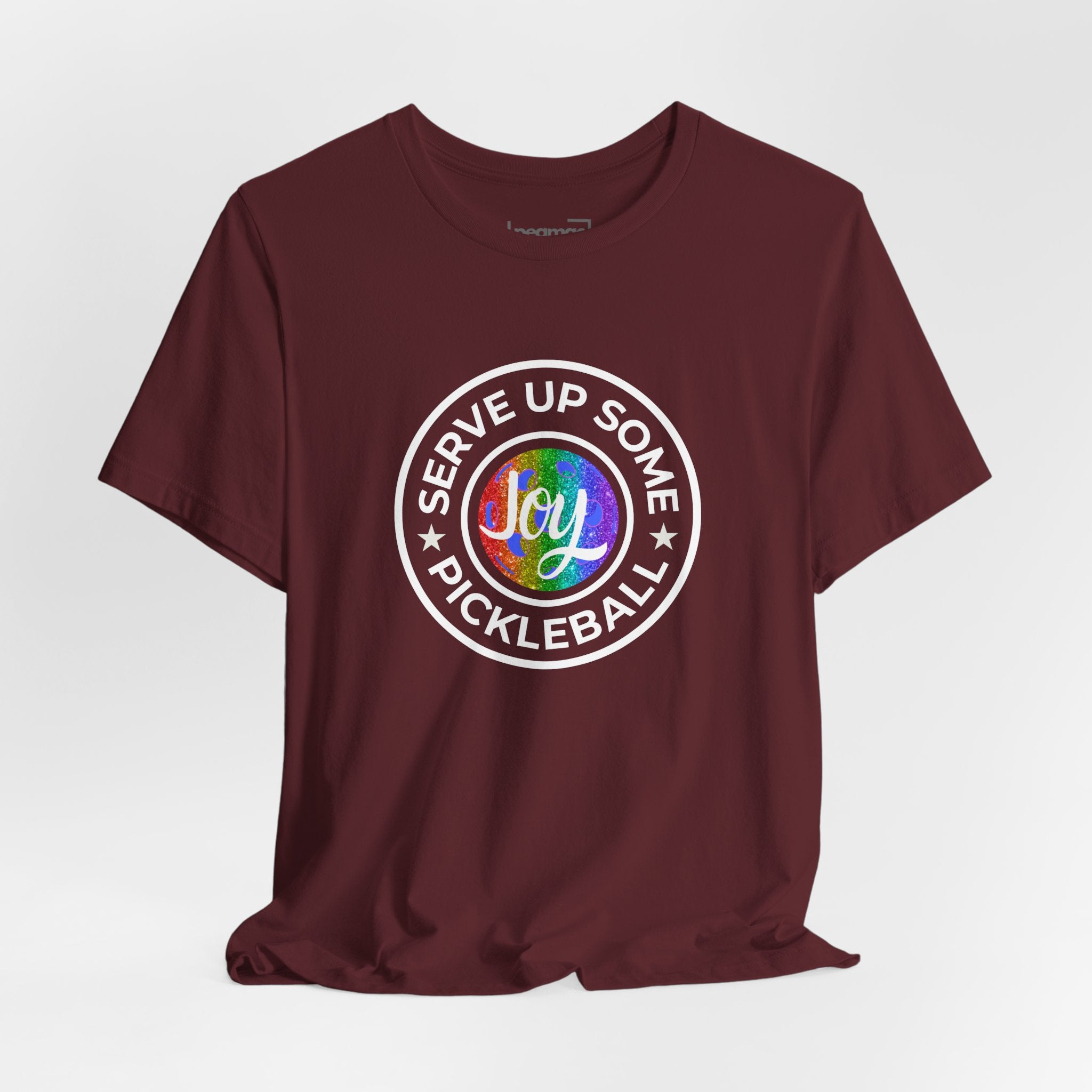 LGBTQ2 pride T-shirt featuring colorful pickleball design and "Serve Up Some Joy" message, made by Printify.
