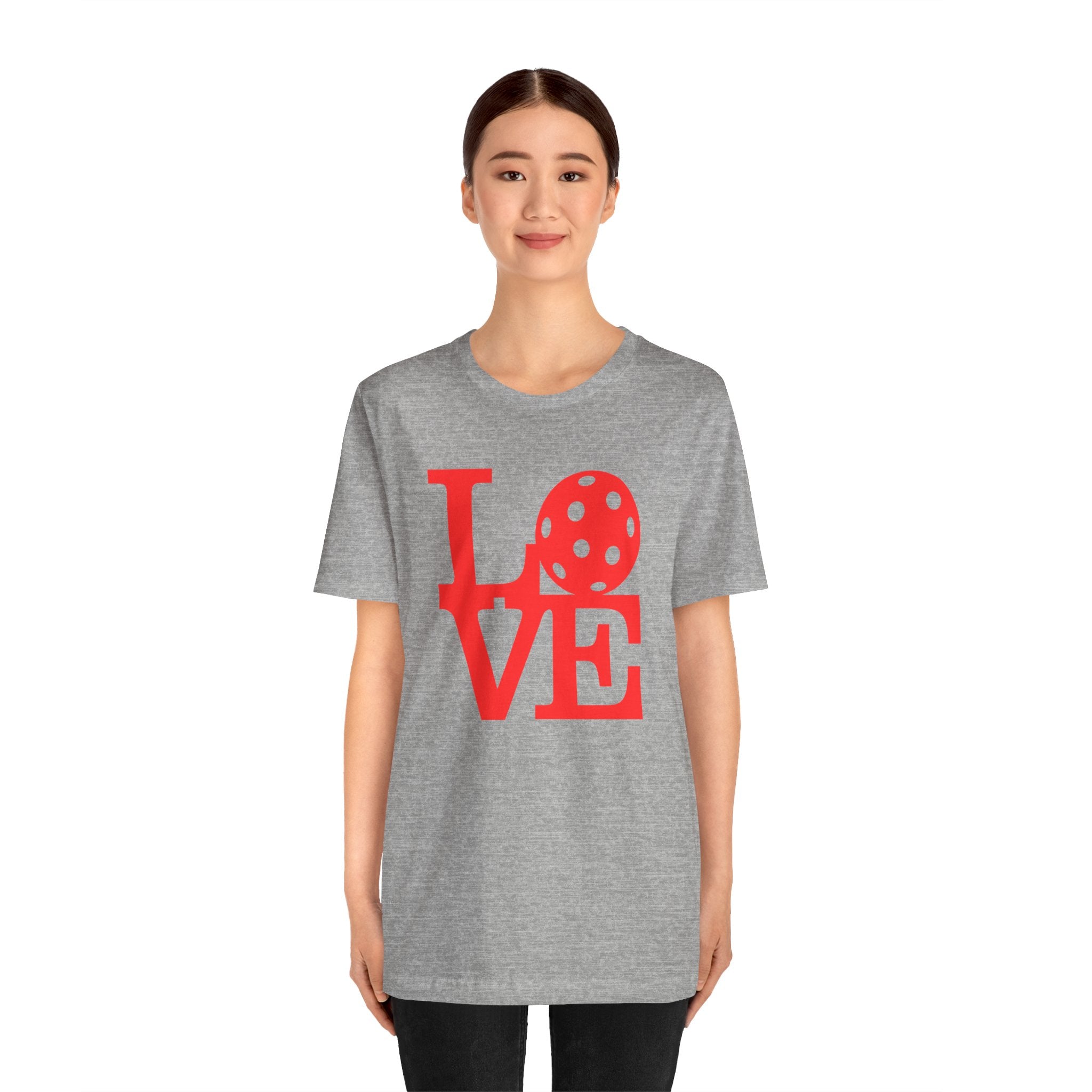 Red LOVE Pickleball graphic T-shirt by Printify featuring bold pop art design, casual crewneck style, in a vibrant, eye-catching print.