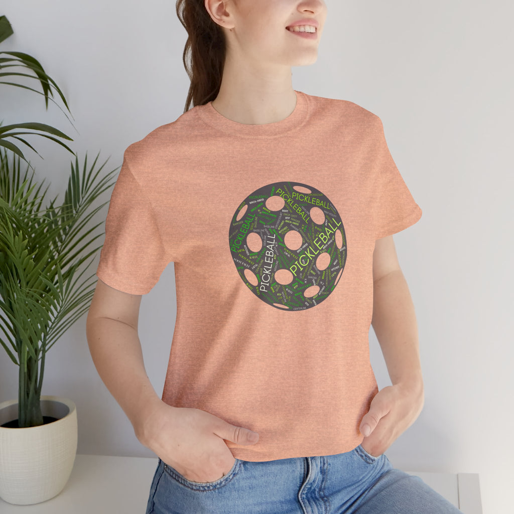 Pickleball Word Cloud T-shirt featuring a pickleball-shaped graphic with words like dink, pickle, and kitchen on a casual tee.