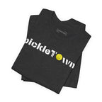 Toronto PickleTOwn T-Shirt featuring CN Tower and Pickleball ‘O’ design, casual unisex tee by Printify.