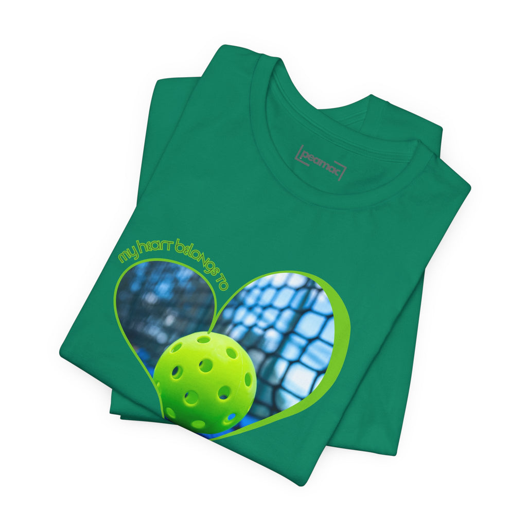 White pickleball T-shirt with "My Heart Belongs to Pickleball" slogan, designed for players and fans, by Printify.