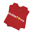 Toronto PickleTOwn T-Shirt featuring CN Tower and Pickleball ‘O’ design, casual graphic tee for pickleball fans.