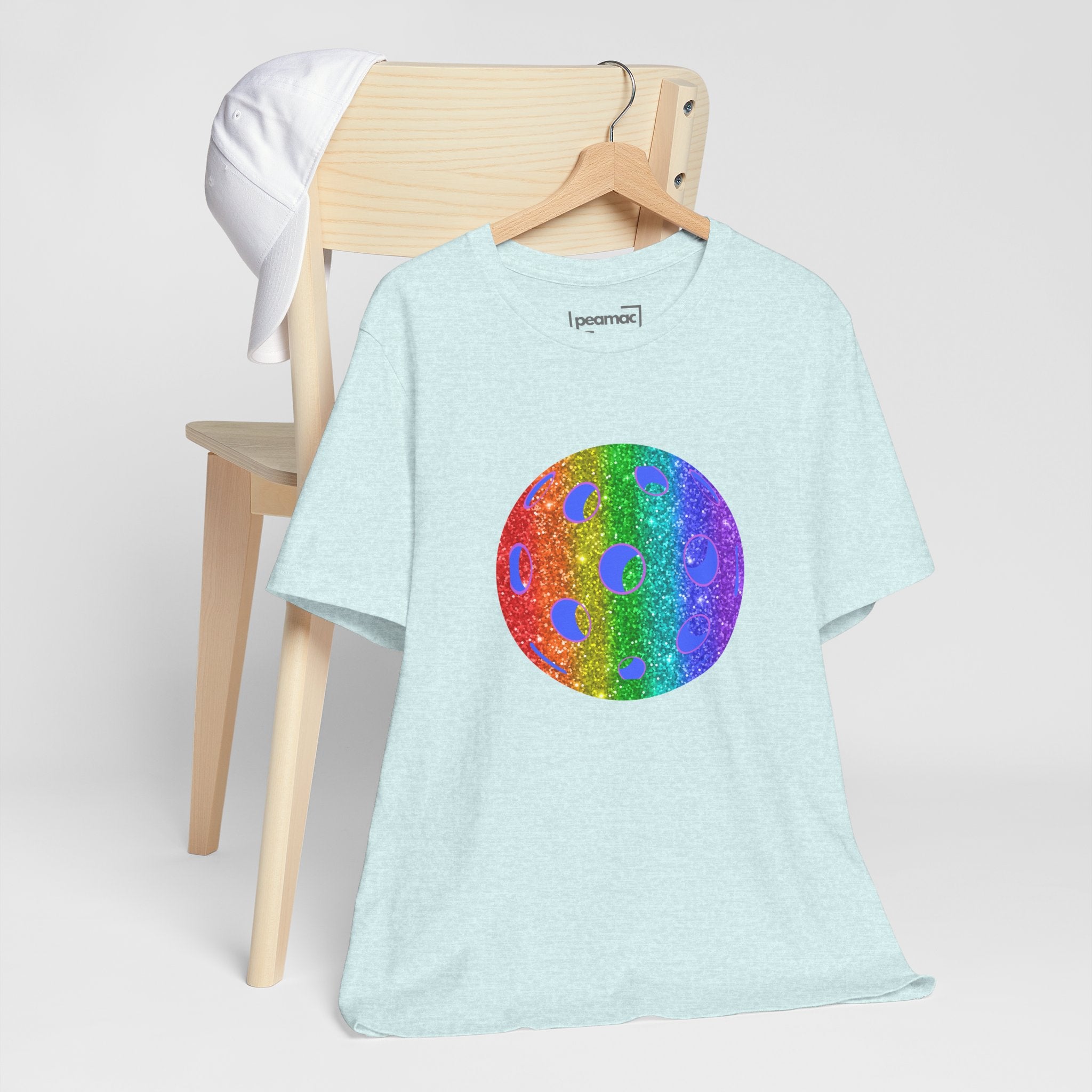 Rainbow glitter pickleball pride T-shirt by Printify featuring bold "Loud and Proud" design on a colorful Pride-themed shirt.