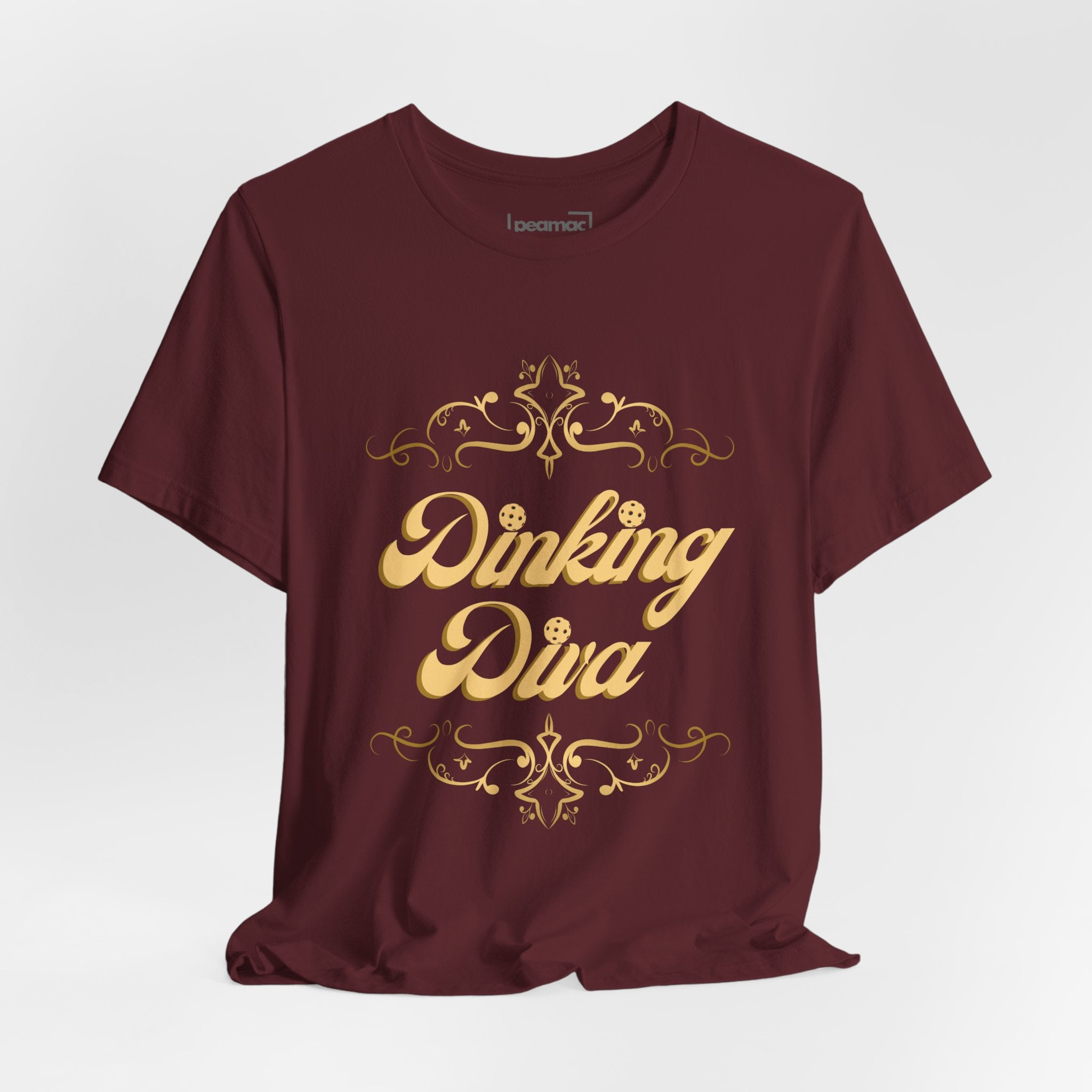 Dinking Diva Pickleball T-shirt in gold filigree print, casual fit, white fabric, designed for pickleball enthusiasts.