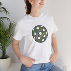 Graphic T-shirt featuring a pickleball word cloud with words like Dink, Pickle, and Kitchen on a casual printify tee.