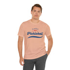 Red and blue pickleball script tee T-shirt featuring paddle and ball design, perfect for pickleball players and fans.