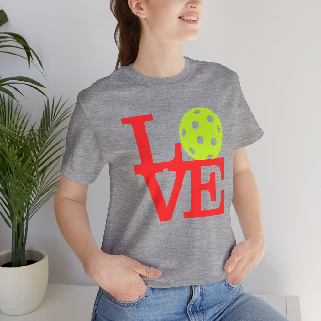 Neon pop art LOVE pickleball T-shirt by Printify, vibrant graphic design on a casual premium cotton T-shirt.