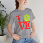 Neon pop art LOVE pickleball T-shirt by Printify, vibrant graphic design on a casual premium cotton T-shirt.