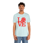 Red LOVE Pickleball graphic T-shirt with bold pop art design, casual unisex printwear by Printify.