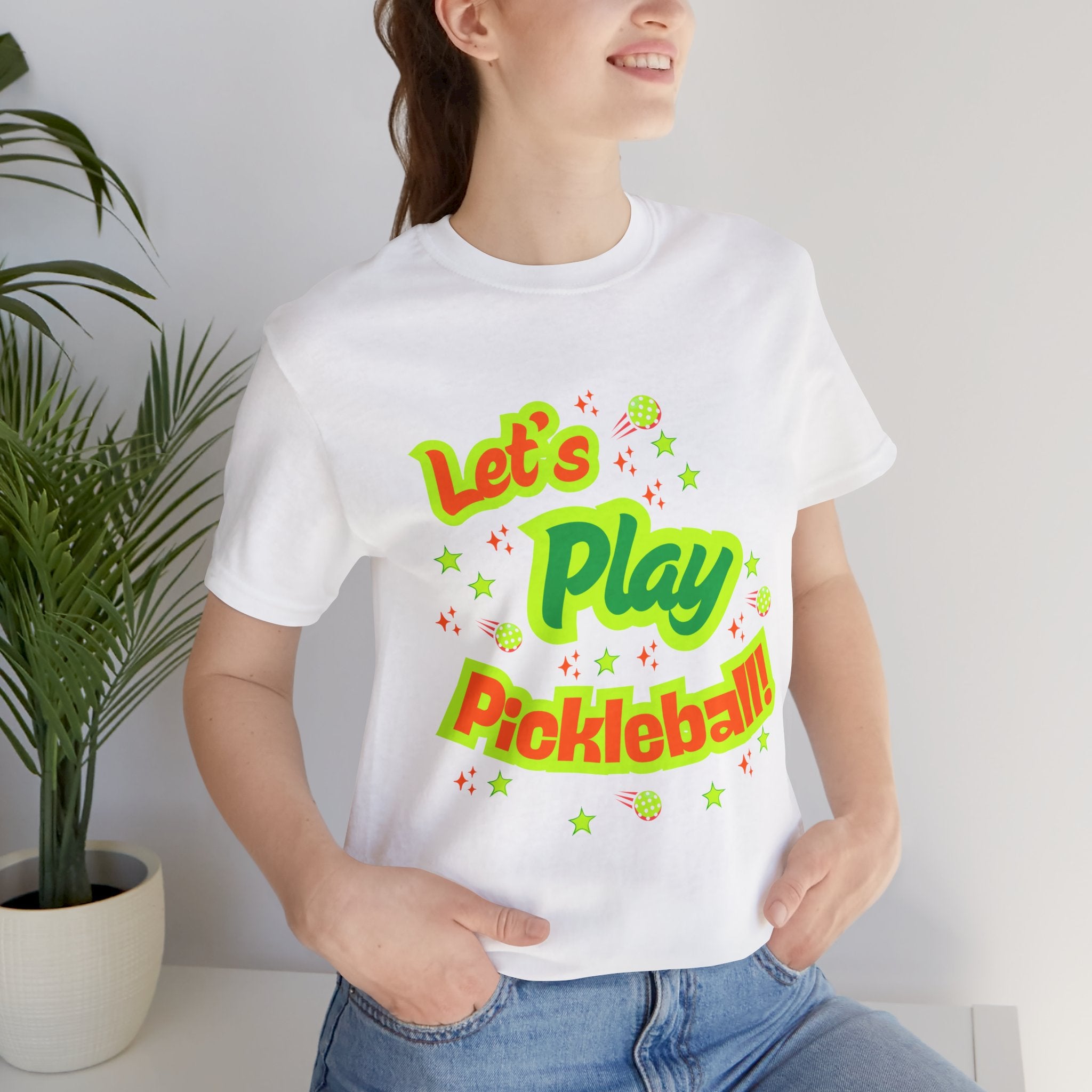 Neon orange and electric green pickleball rally graphic T-shirt by Printify, featuring vibrant court design and casual fit.
