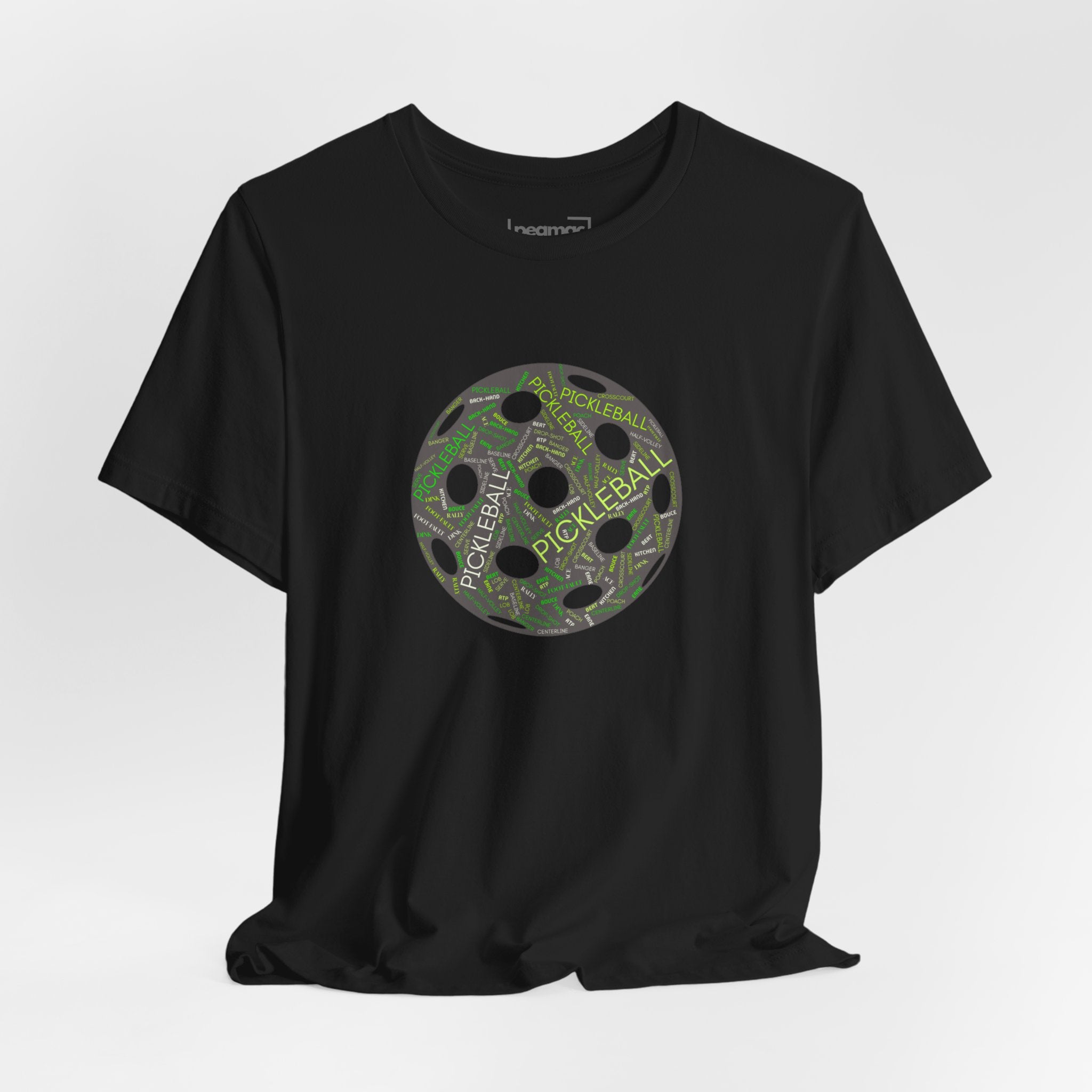 Pickleball Word Cloud T-Shirt with pickleball-shaped graphic featuring words like dink, pickle, and kitchen on a casual tee.