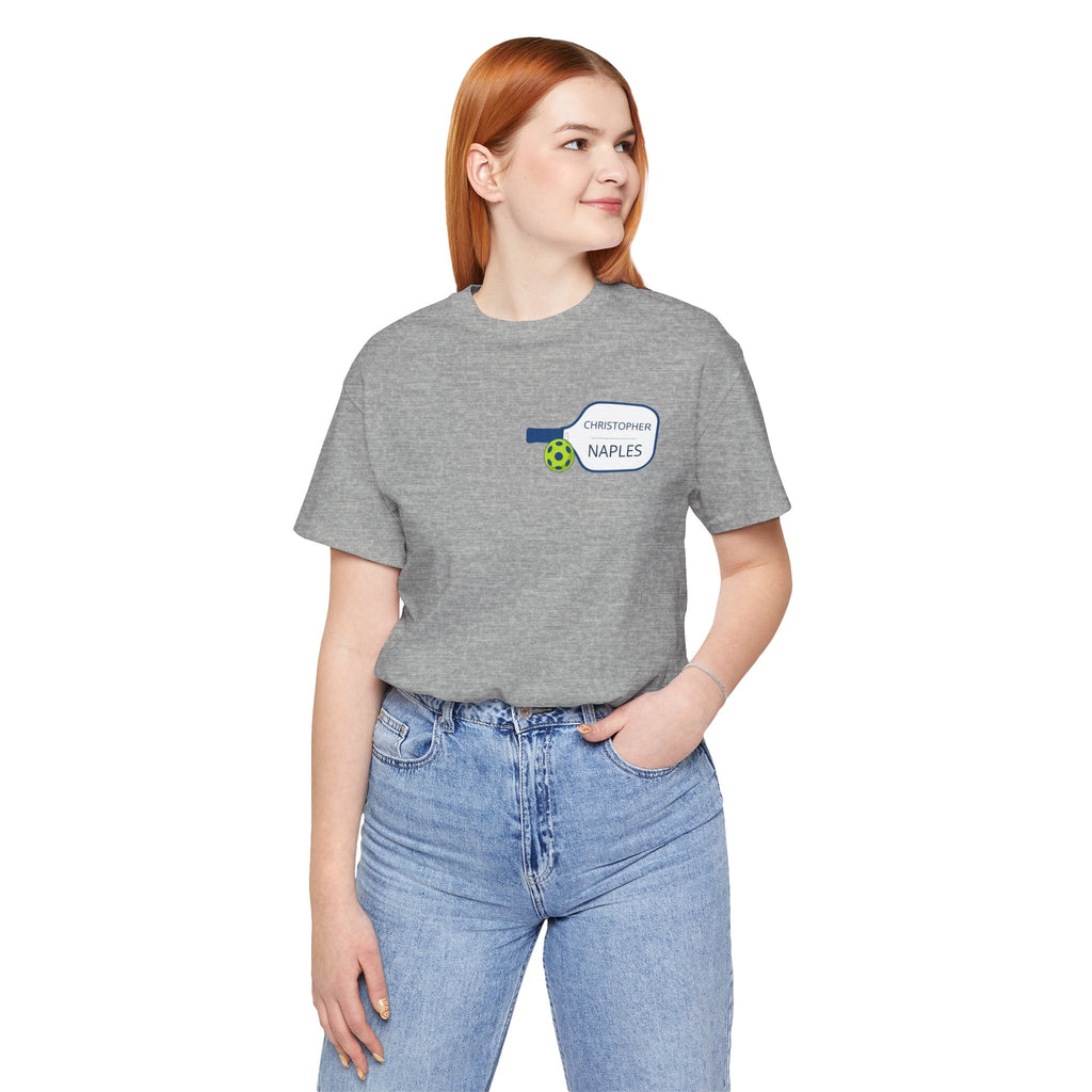 Personalized pickleball T-shirt with custom name and club logo on paddle graphic, printed by Printify.