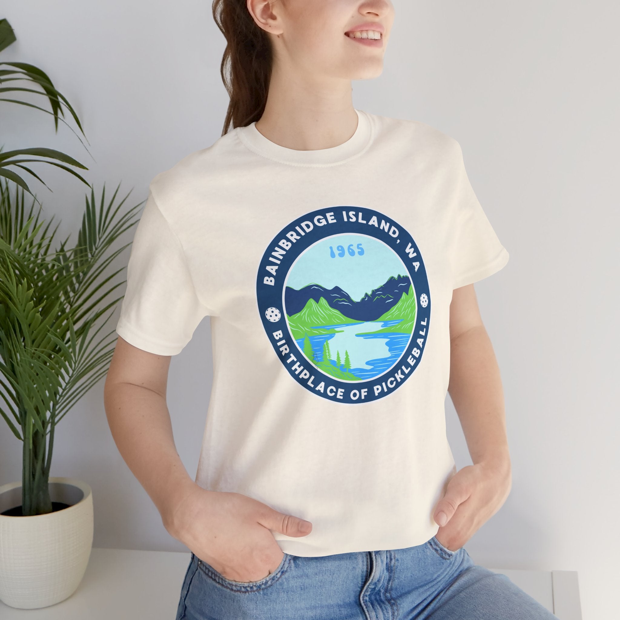 Unisex Bainbridge Island Pickleball T-Shirt featuring "Birthplace of Pickleball 1965" logo in black and white print.