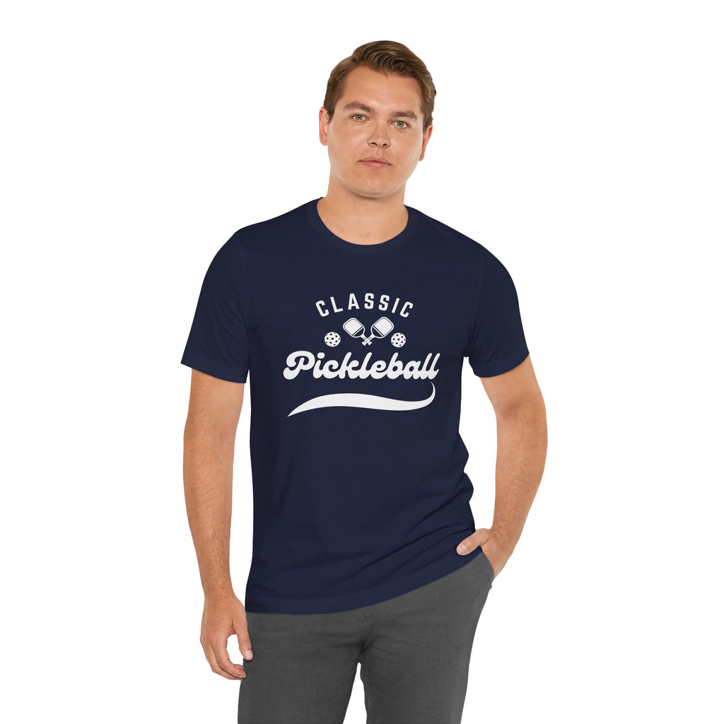 White pickleball t-shirt with "Pickleball" script design, classic fit, printed by Printify, ideal for casual sportswear.
