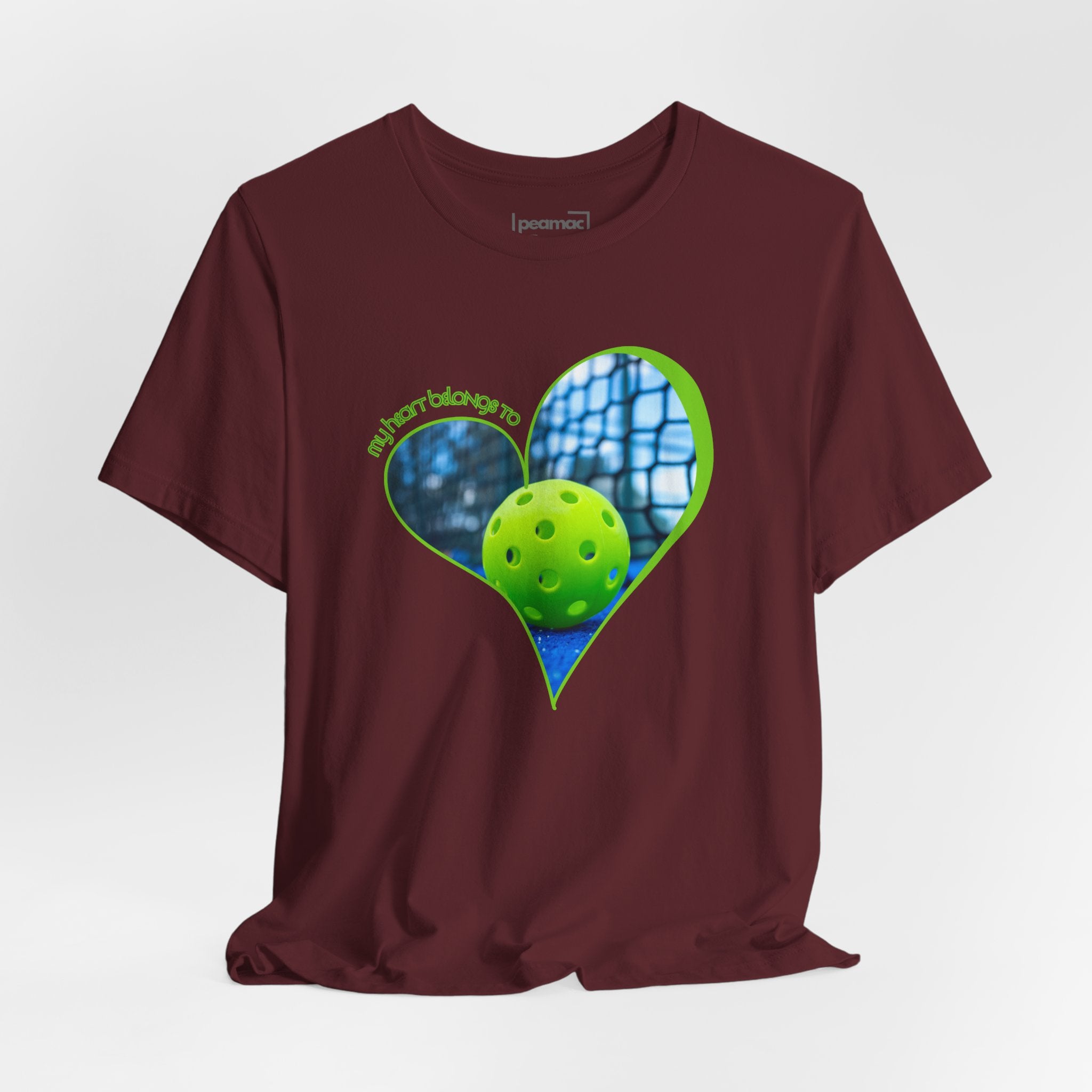 White pickleball T-shirt with "My Heart Belongs to Pickleball" slogan, designed for players and fans, by Printify.