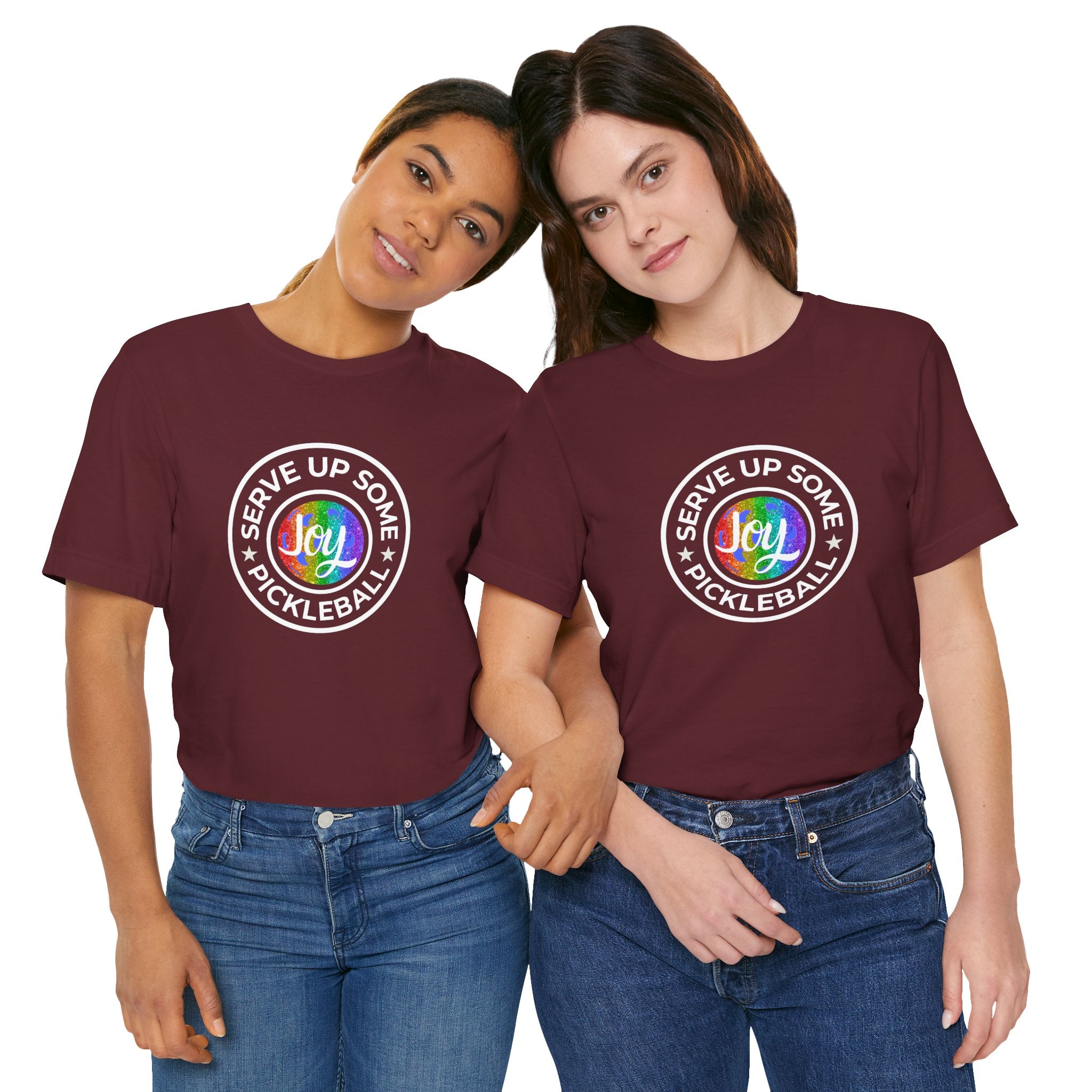 LGBTQ2 pride pickleball T-shirt featuring colorful rainbow design and "Serve Up Some Pickleball Joy" text on a casual cotton tee.