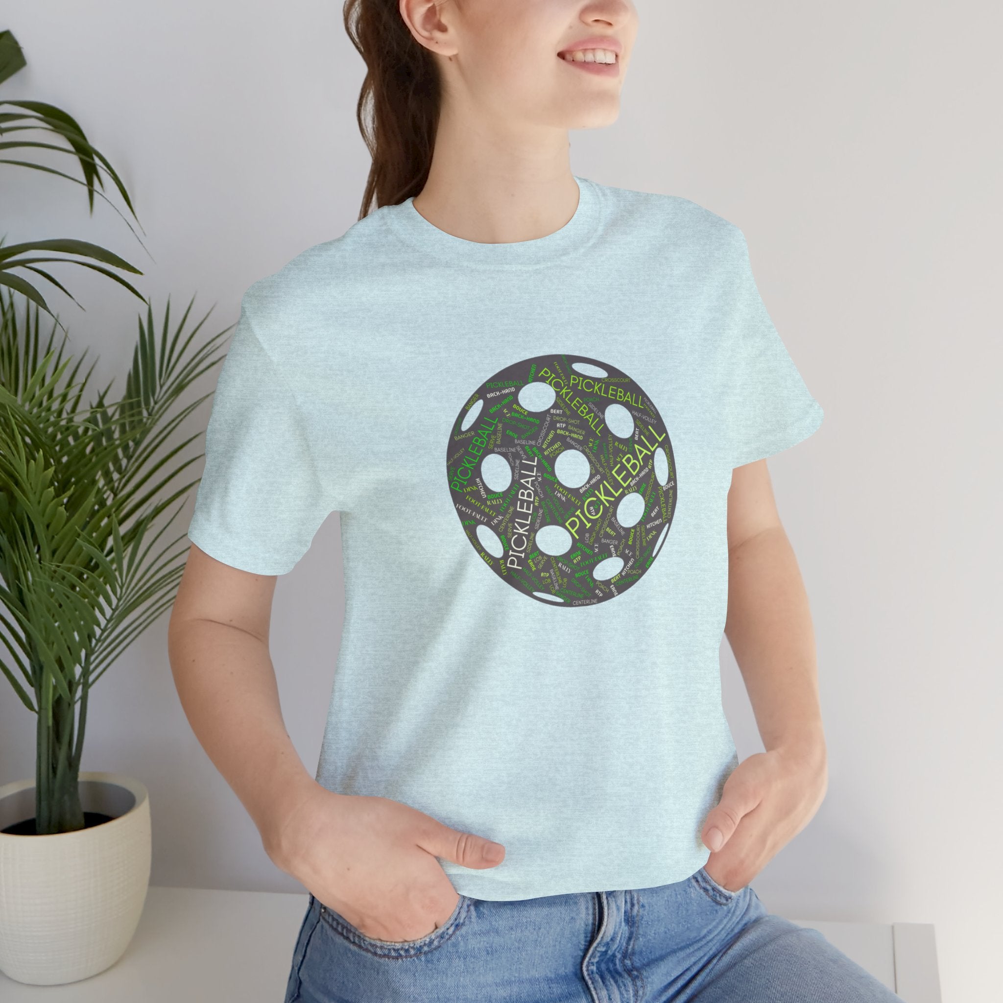 Pickleball Word Cloud T-Shirt with pickleball-shaped graphic, featuring words like Dink, Pickle, and Kitchen, on a casual tee.