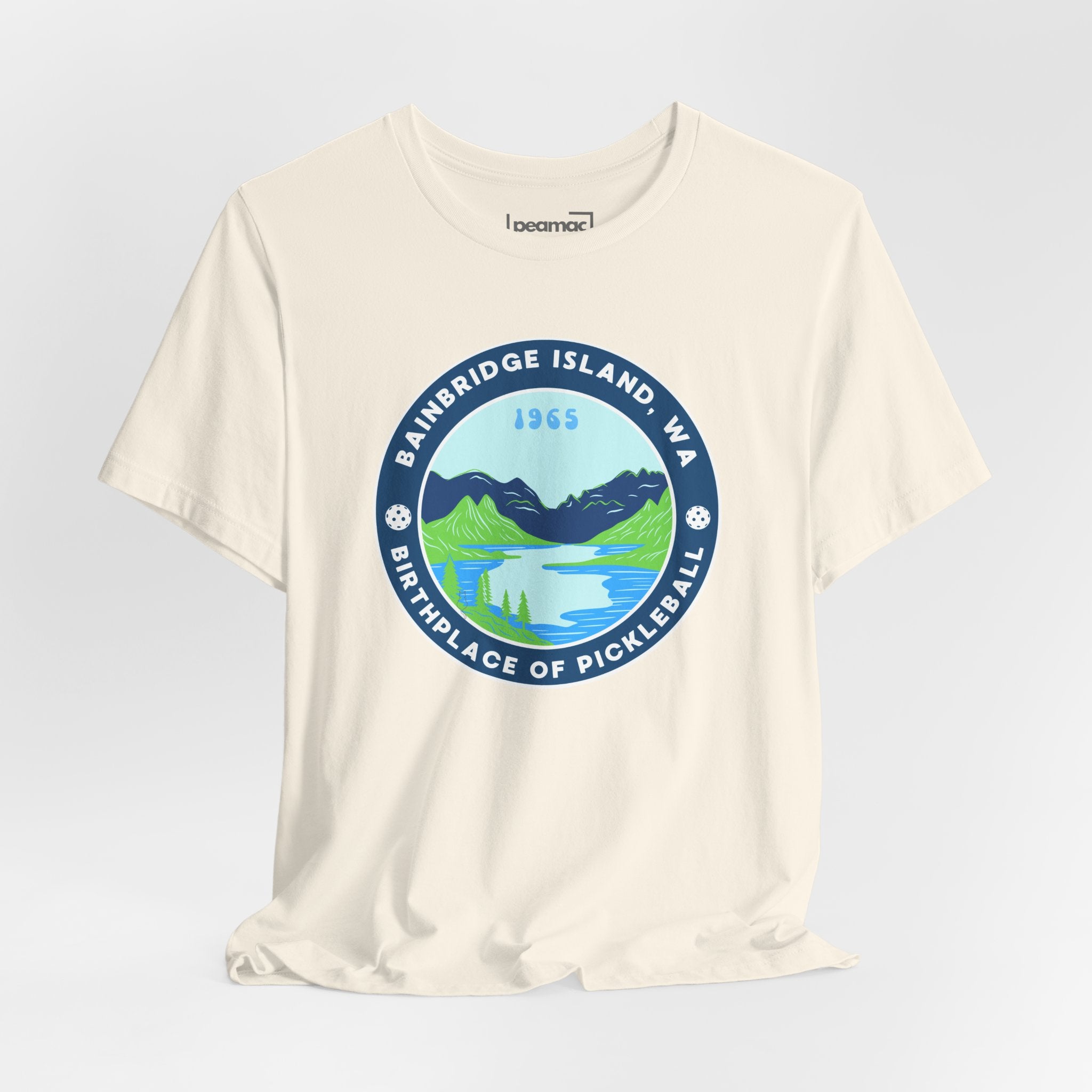 White Bainbridge Island Pickleball T-shirt with "Birthplace of Pickleball 1965" text, unisex fit and printed by Printify.