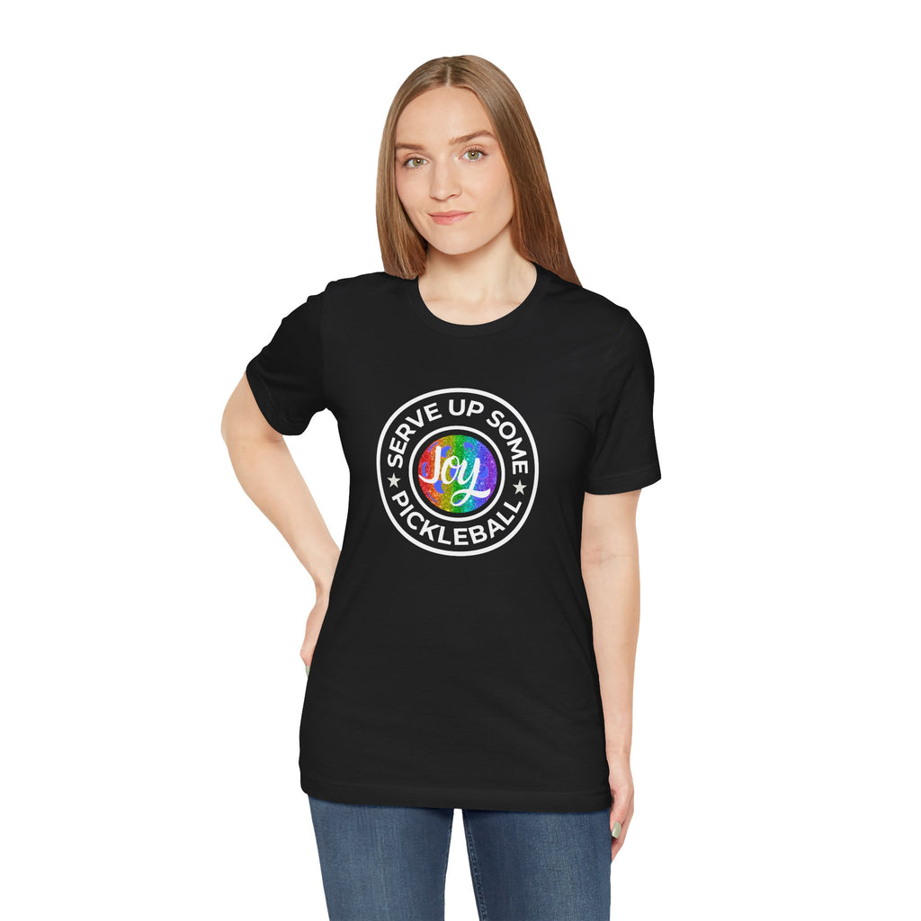 LGBTQ2 pride pickleball T-shirt featuring colorful rainbow design and playful "Serve Up Some Pickleball Joy" slogan on white fabric.