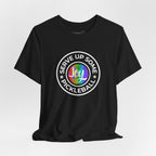 LGBTQ2 pride T-shirt featuring a pickleball design, vibrant colors, and "Serve Up Some Pickleball Joy" printed on a comfortable Printify tee.