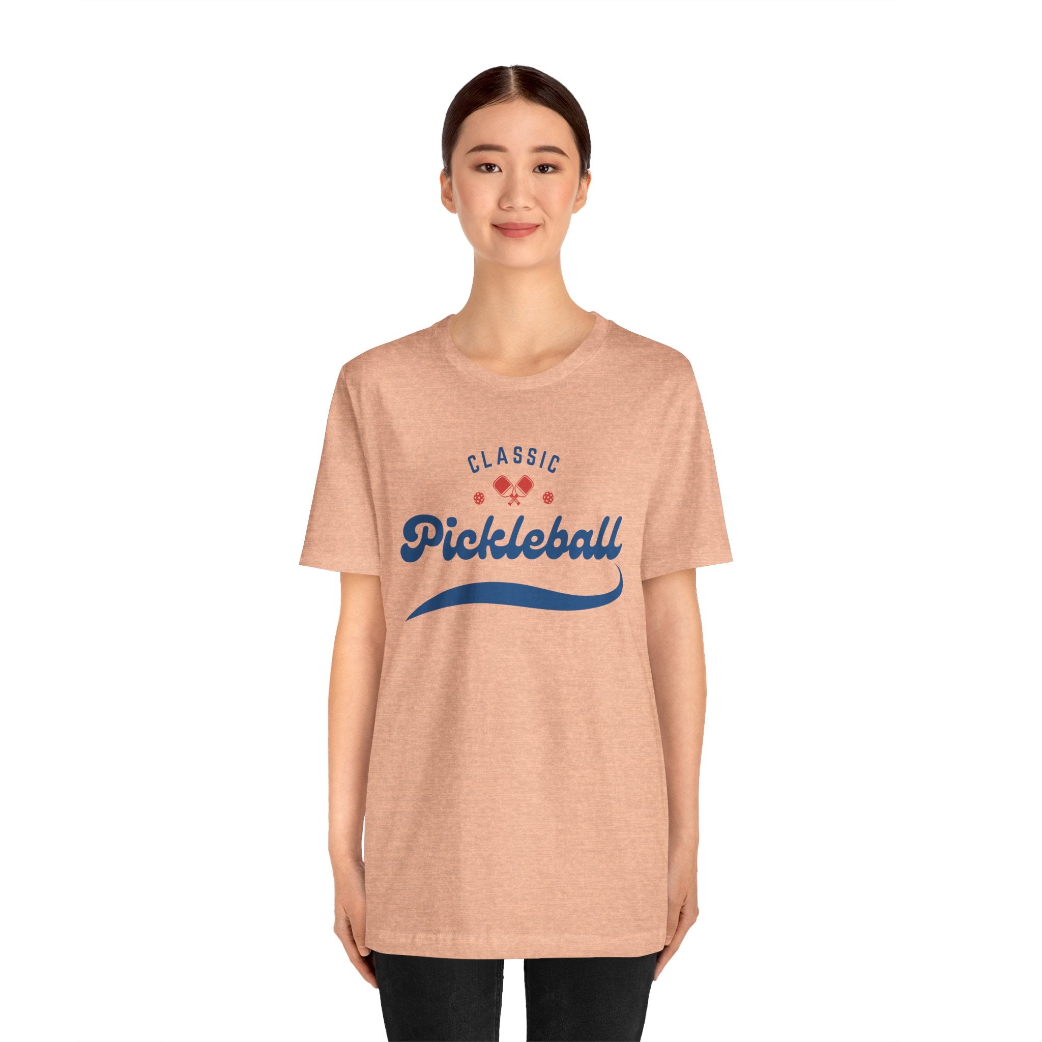 Red and blue pickleball T-shirt featuring paddle and ball graphic, classic script print, by Printify.