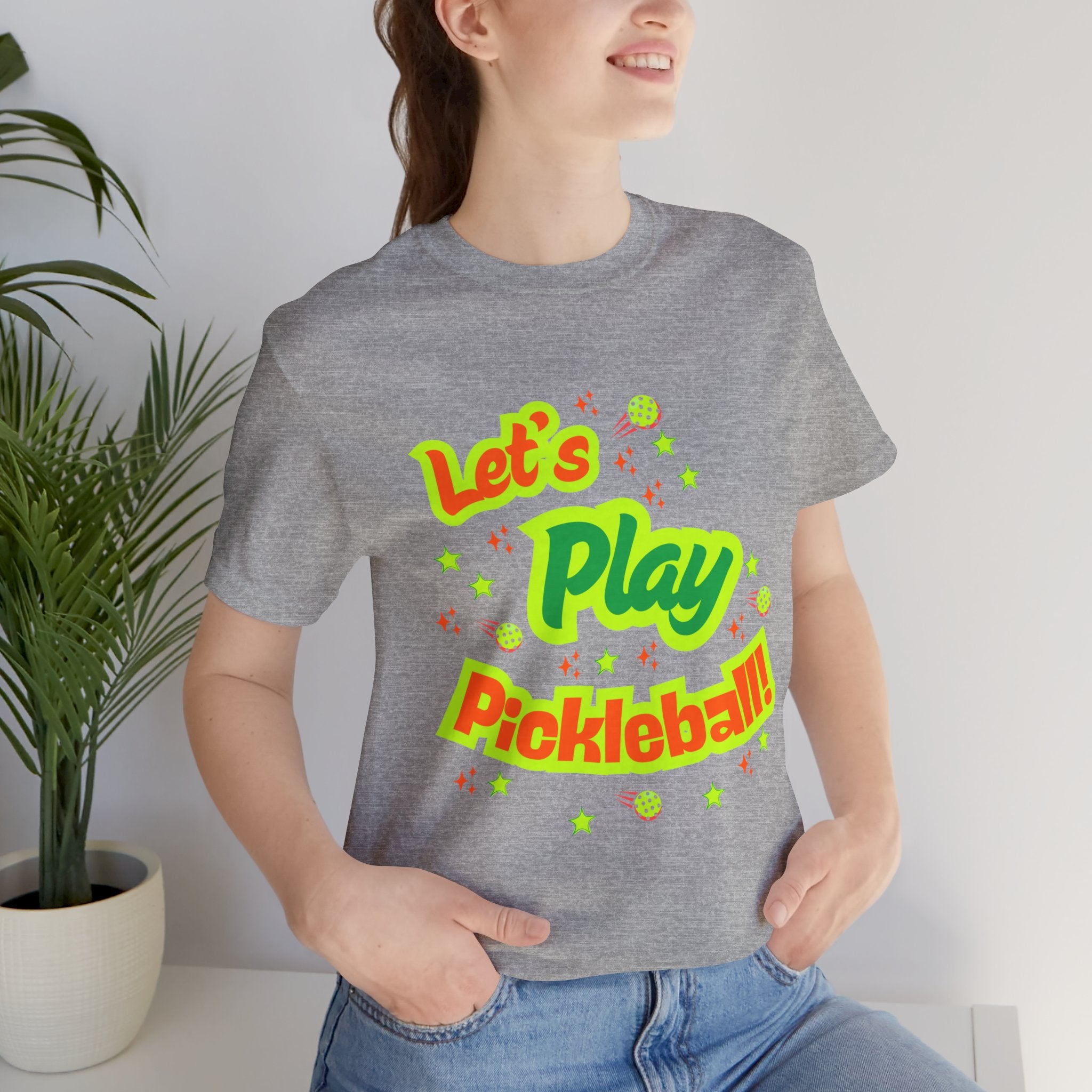 Neon orange and electric green pickleball rally graphic T-shirt by Printify, colorful court design on casual graphic tee