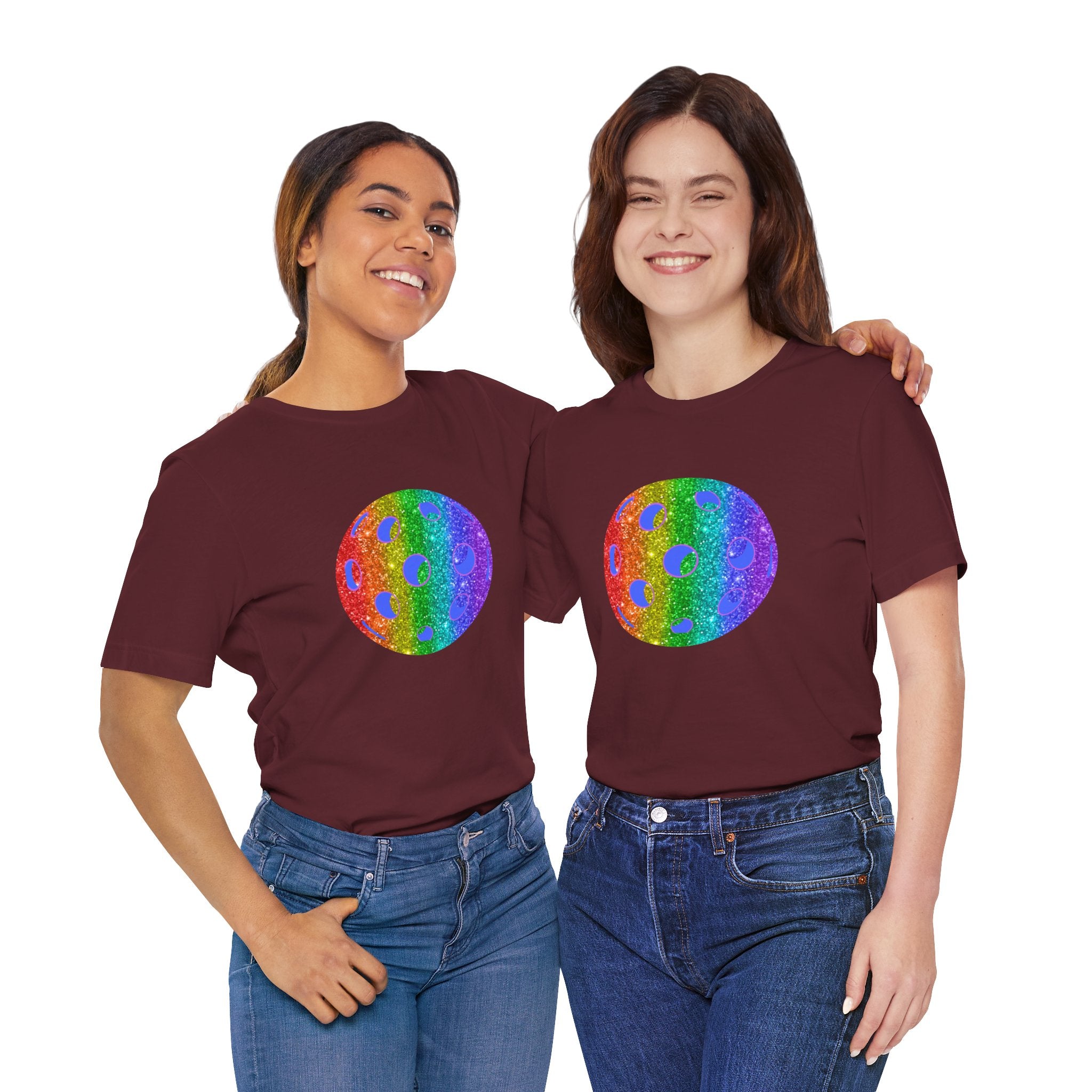 Rainbow glitter pickleball pride T-shirt by Printify featuring bold "Loud and Proud" text and colorful pickleball graphics.