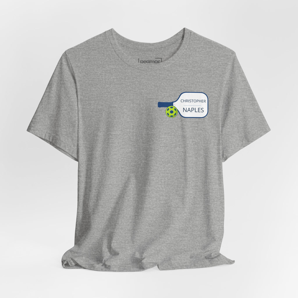 Personalized pickleball T-shirt with custom name and club graphic design, featuring a paddle illustration and vibrant colors.