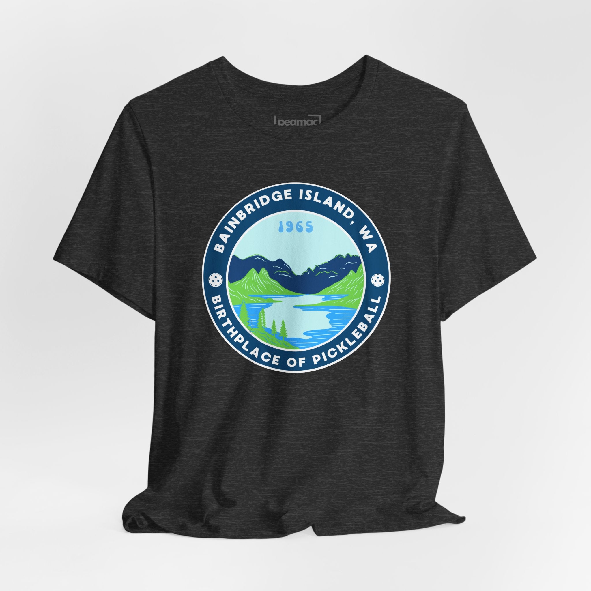 Unisex Bainbridge Island Pickleball T-Shirt with "Birthplace of Pickleball 1965" text, featuring a casual, comfortable fit and printed design.