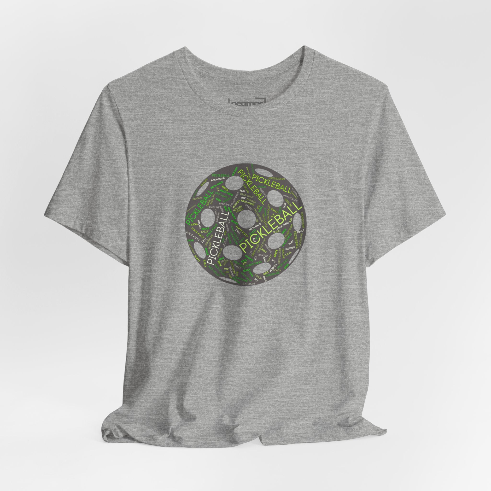Pickleball Word Cloud T-Shirt with pickleball-shaped graphic, featuring words like dink, pickle, and kitchen on a casual printify tee.