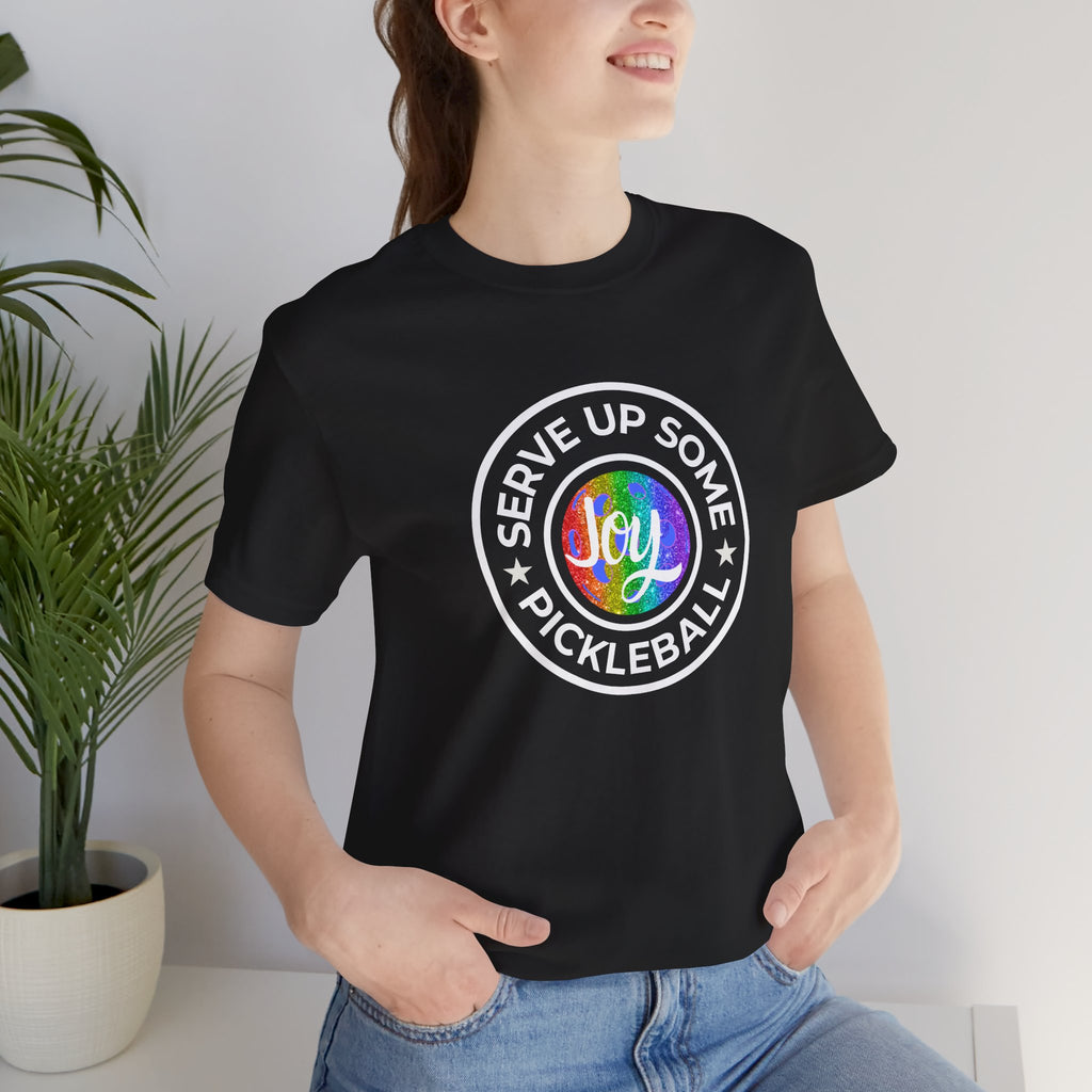 LGBTQ2 pride T-shirt featuring a colorful pickleball design and the message "Serve Up Some Pickleball Joy" on a white Printify tee.