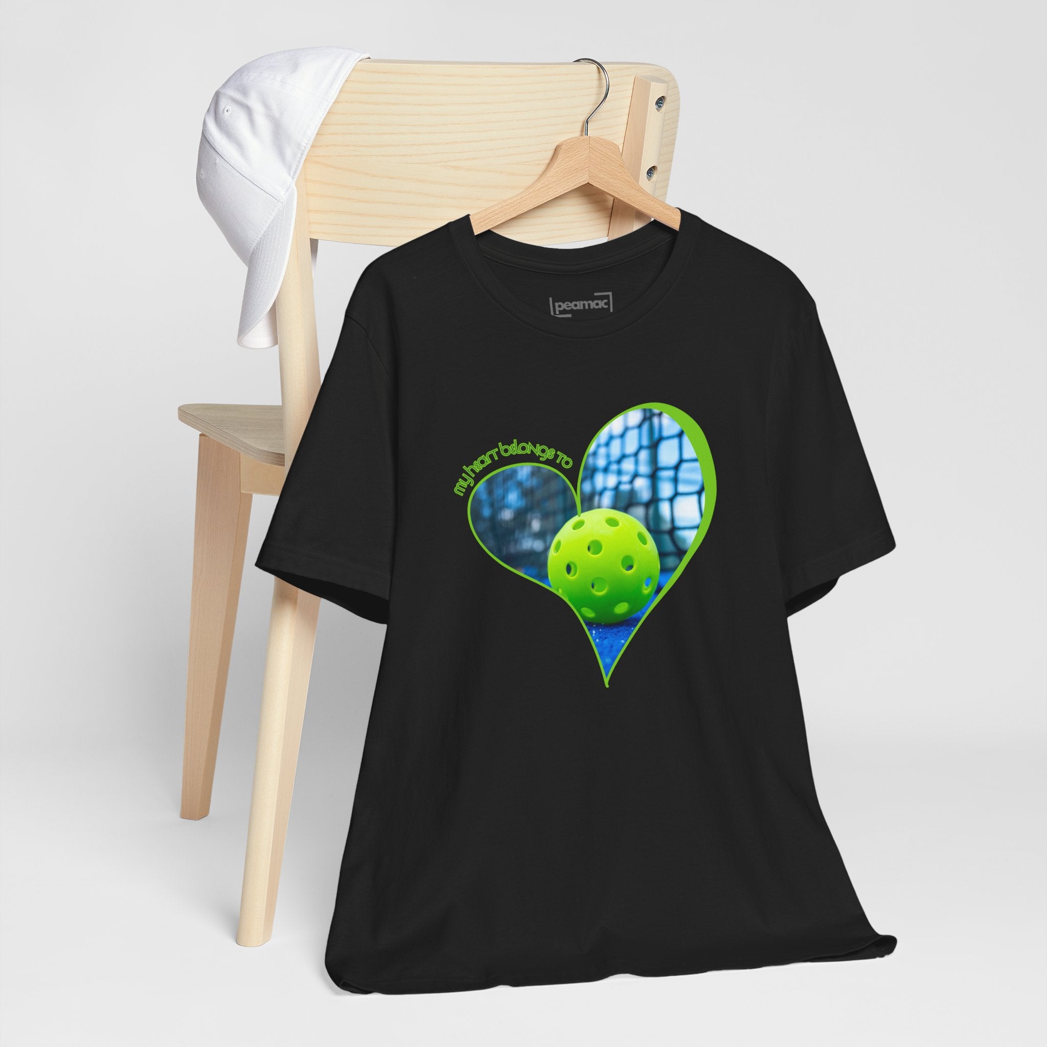 White pickleball t-shirt with "My Heart Belongs to Pickleball" printed in black, designed for players and fans.