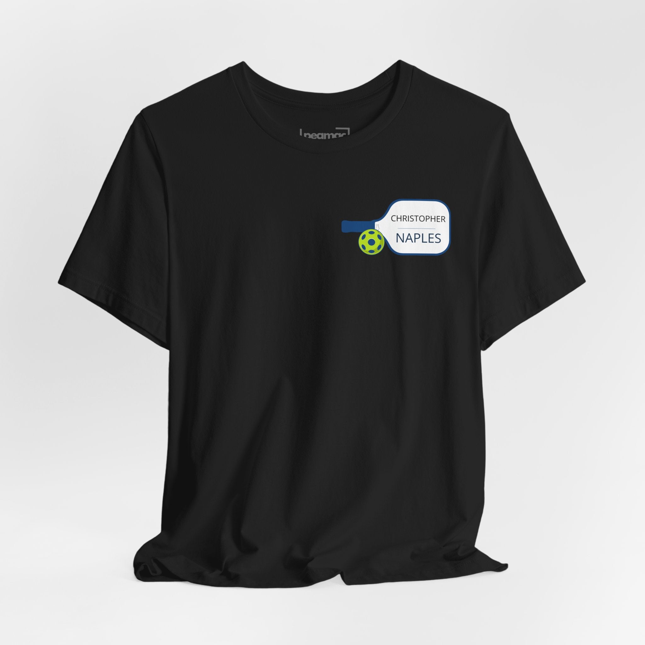 Personalized pickleball T-shirt with custom name and club logo featuring a paddle graphic design, by Printify.