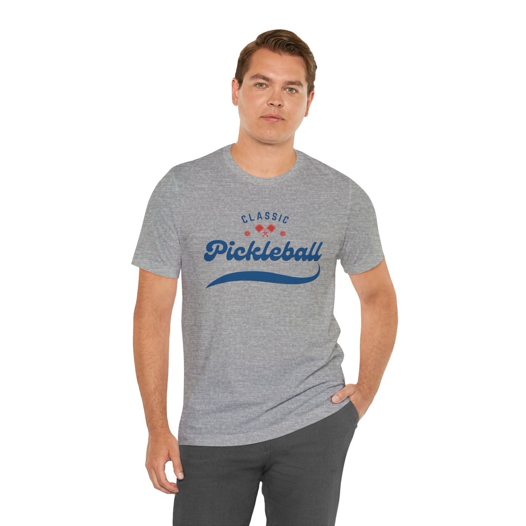 Red and blue pickleball T-shirt with script logo, paddle, and ball design, made by Printify.