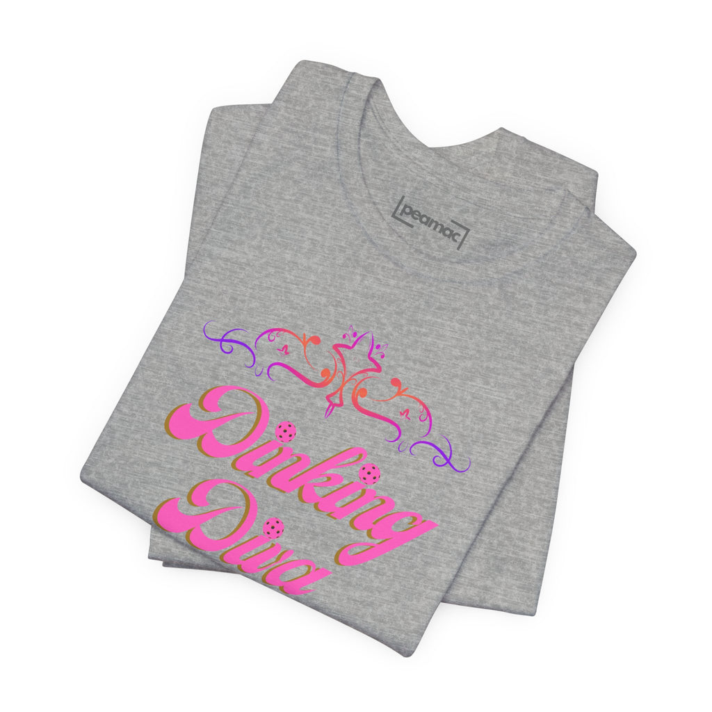 Pink Dinking Diva pickleball T-shirt by Printify featuring a stylish filigree design on athletic fabric.