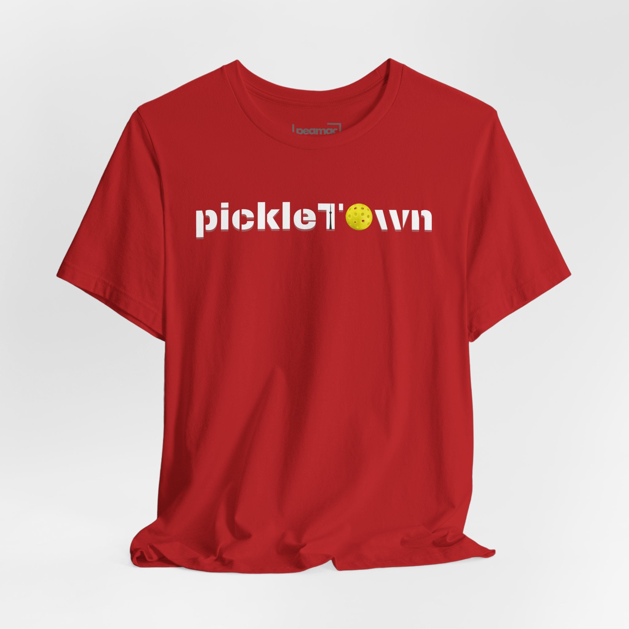 Toronto PickleTOwn T-Shirt featuring CN Tower and Pickleball ‘O’ design, casual printify branded tee for pickleball fans.