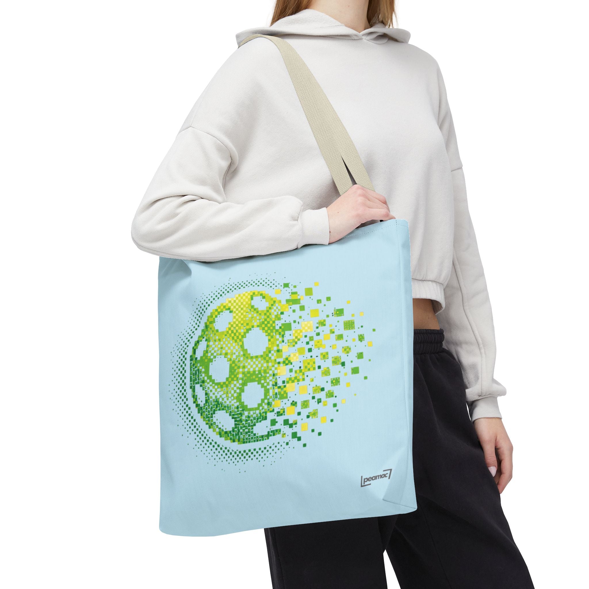 Pixelated pickleball tote bag in green, yellow, and light blue with digital smash design, 18x18 inches, by Printify.