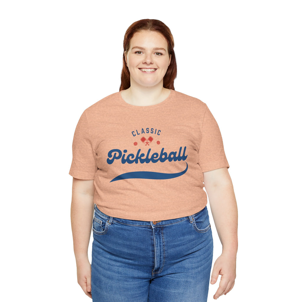 Red and blue pickleball script T-shirt featuring paddle and ball graphic, perfect for pickleball enthusiasts.