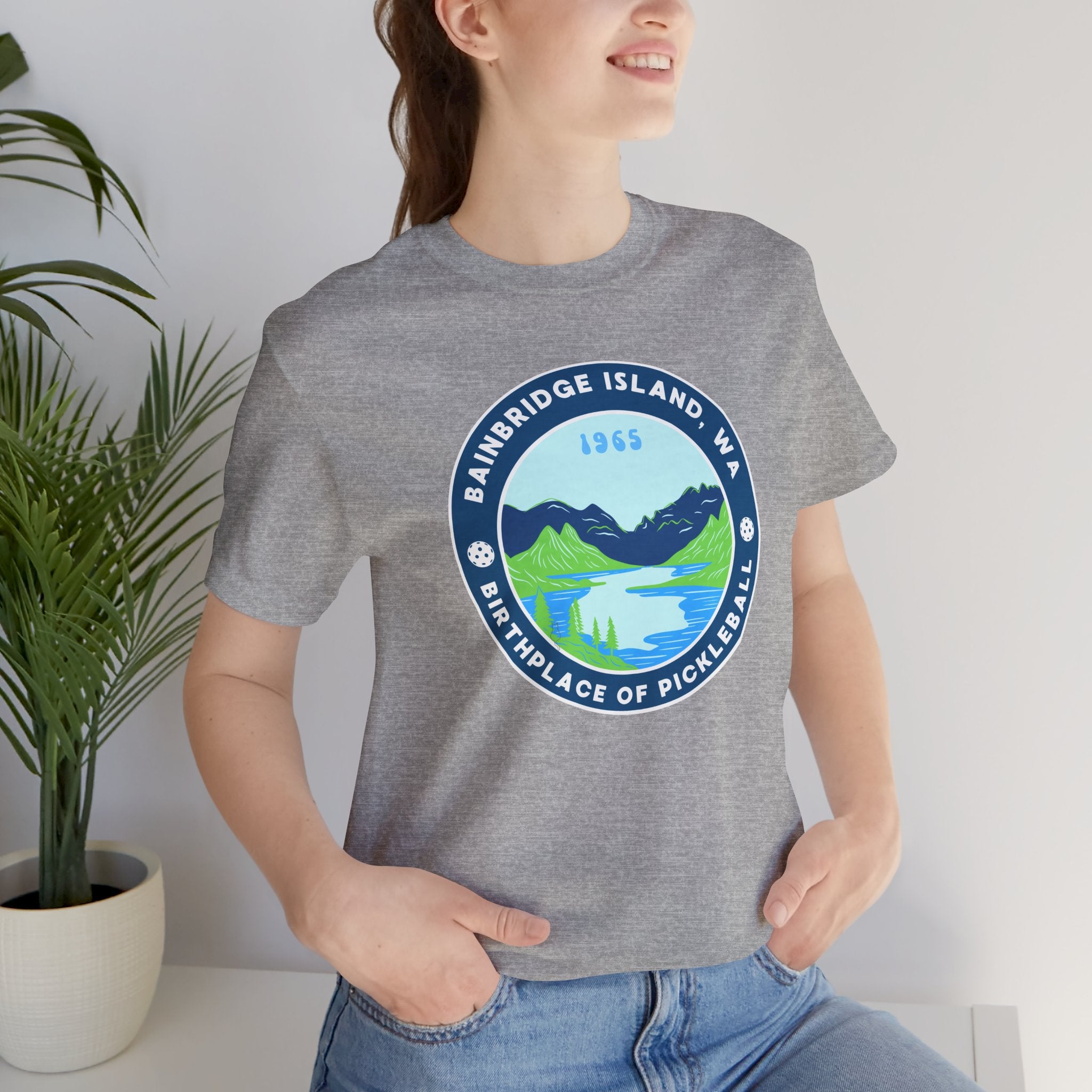 Unisex Bainbridge Island Pickleball T-Shirt featuring the "Birthplace of Pickleball 1965" logo in black and white print.