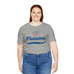 Red and blue pickleball script T-shirt with paddle and ball design, casual men's or women's graphic tee from Printify.