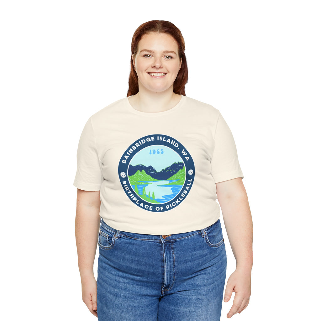 Unisex Bainbridge Island Pickleball T-Shirt featuring the "Birthplace of Pickleball 1965" design in black on a white fabric.