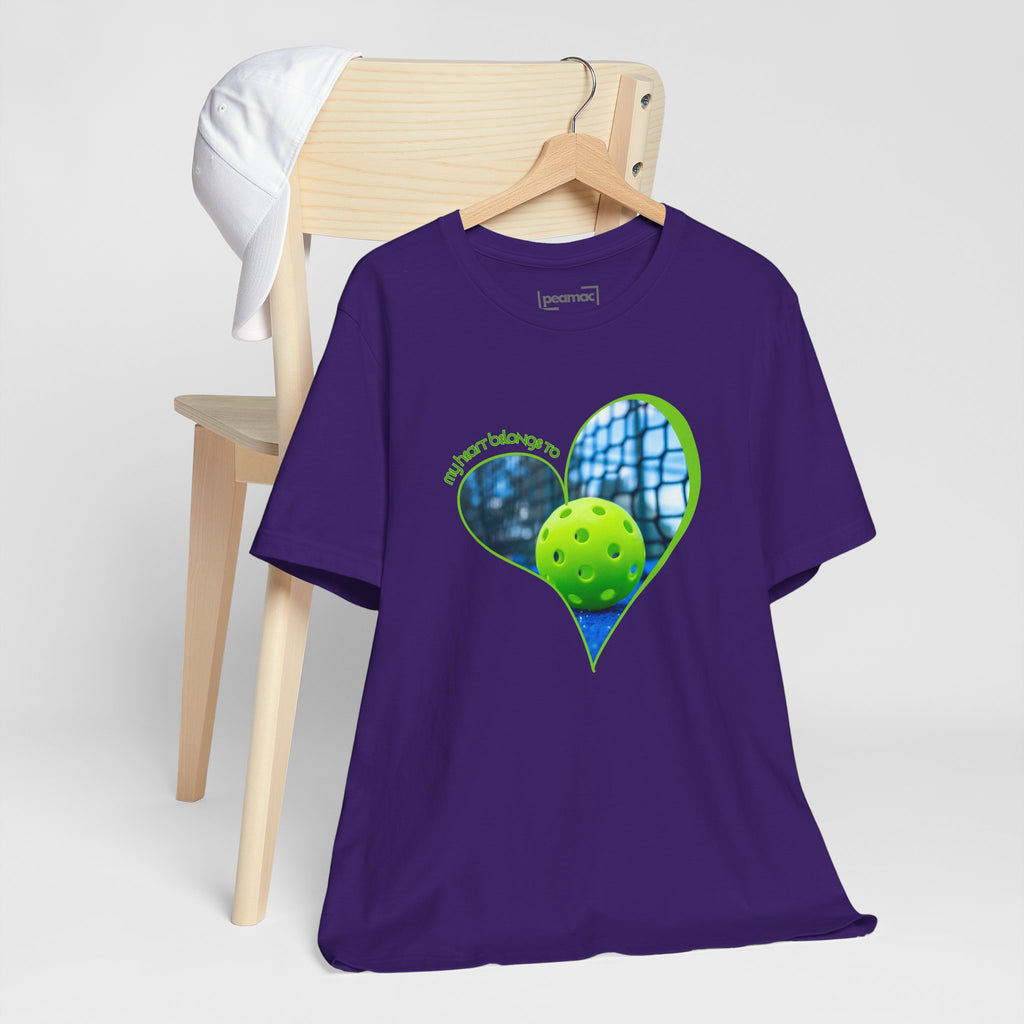 White pickleball T-shirt with "My Heart Belongs to Pickleball" slogan, for players and fans, by Printify.