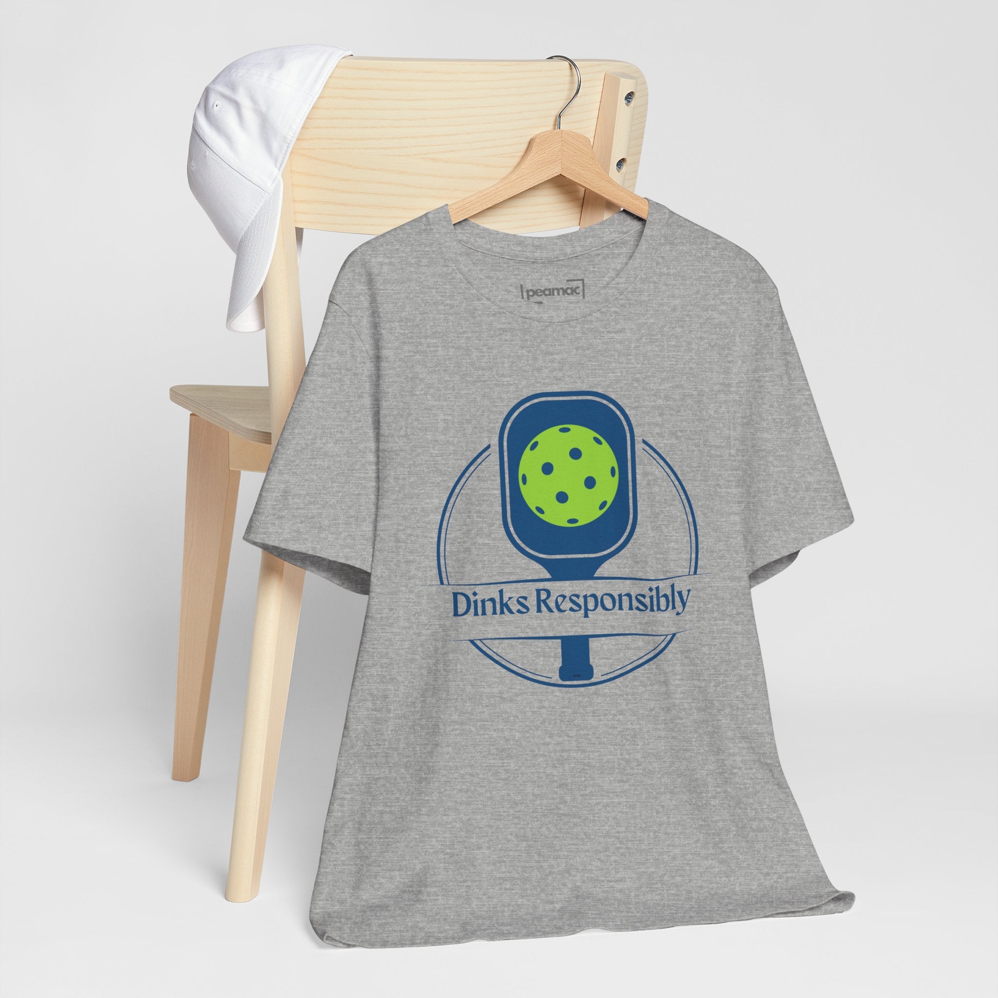 Dinks Responsibly pickleball T-shirt with paddle and ball graphic, humorous pickleball shirt by Printify.