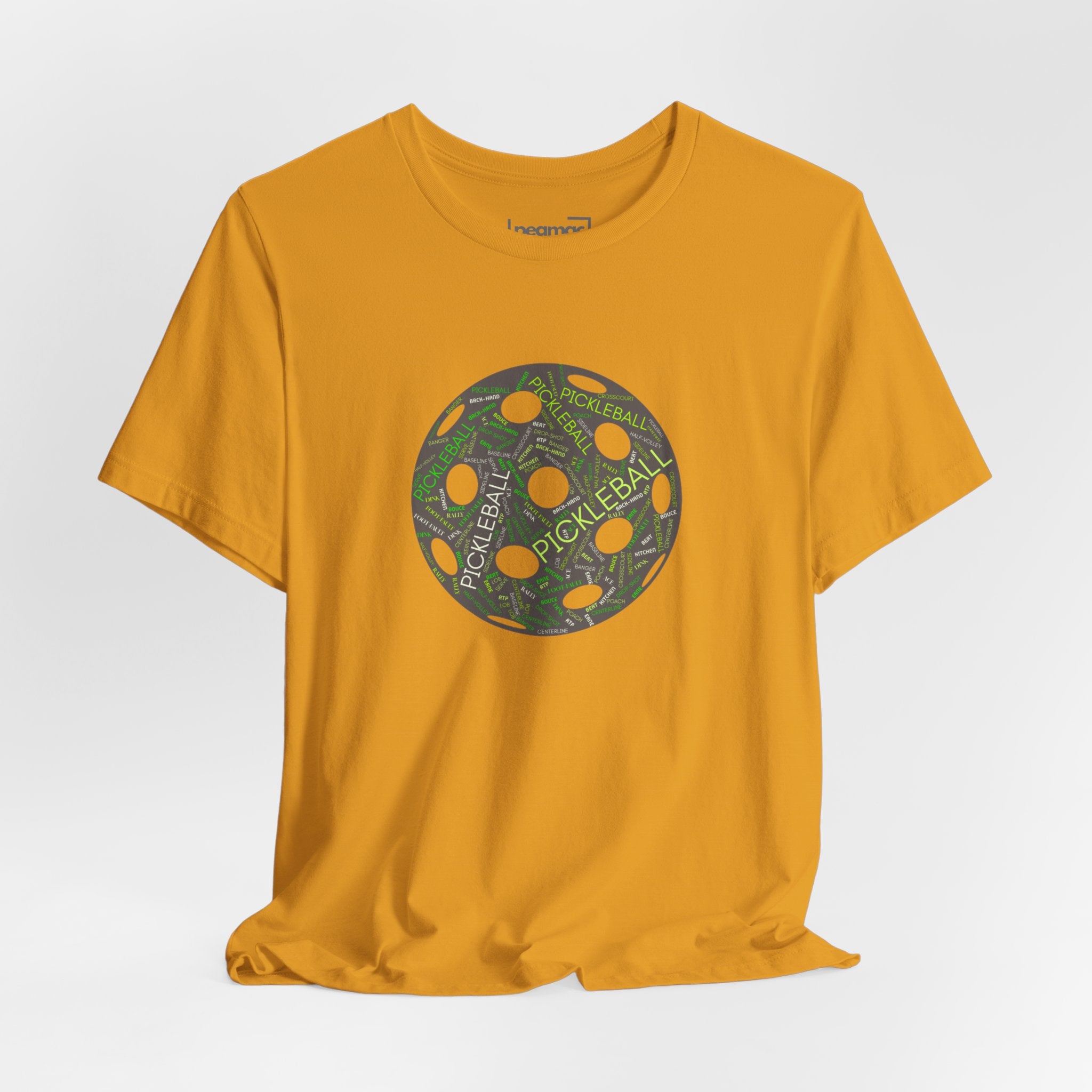 Pickleball Word Cloud T-Shirt featuring a pickleball-shaped graphic with words like Dink, Pickle, and Kitchen, by Printify.