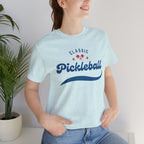 Red and blue pickleball script tee featuring paddle and ball design, casual t-shirt by Printify.